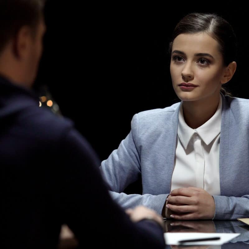 female-lawyer-looking-at-client-with-smile-giving-hope-for-release-from-prison