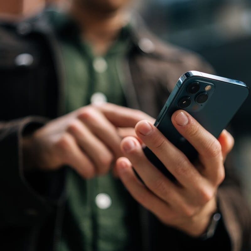 Person using a smartphone to contact a criminal lawyer