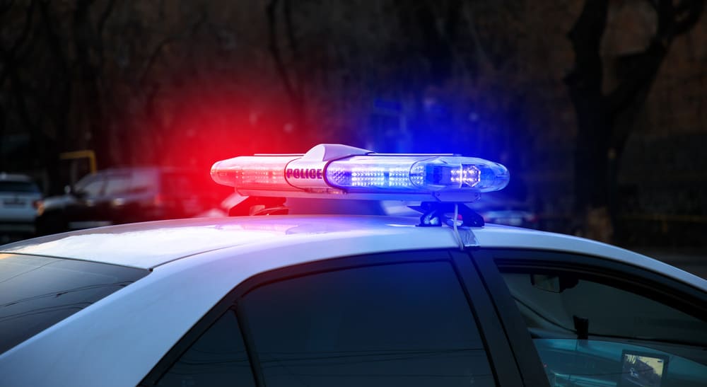 white police car, with the word "POLICE" visible on the light bar.